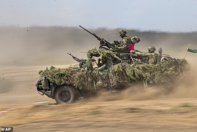 German soldiers take part in the Lithuanian-German division-level international military exercise 'Grand Quadriga 2024' at a training range in Pabrade, north of the capital Vilnius, Lithuania on Wednesday, May 29, 2024