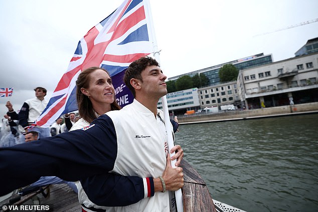 The rain did not abate but boats carried beaming, cheering athletes down the River Seine