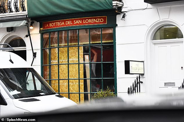 Construction workers were spotted inside the former restaurant bordering up the windows and doors