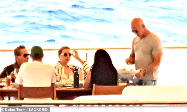 Bezos is seen serving Sanchez her dinner and plating her food, showing who really wears the pants in the relationship