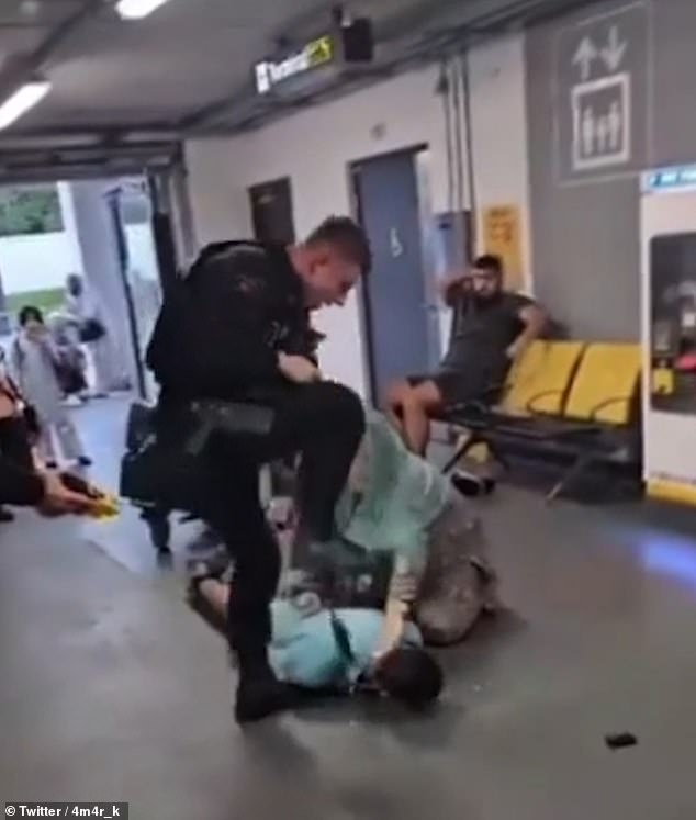 This is the moment in the original footage that sparked controversy after a police officer was seen kicking the young man on the ground in the head - but new footage has now shown what happened in the moments running up to this