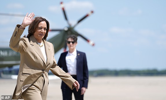 Vice President Kamala Harris, left, waves as she arrives to board Air Force Two at Andrews Air Force Base in Md., Saturday, July 27, 2024. Harris is traveling to Pittsfield, Mass., to participate in a political event. (AP Photo/Stephanie Scarbrough, Pool)