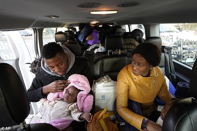 Migrants from Haiti and elsewhere load into a van in Boston headed to a shelter in Quincy, Massachusetts