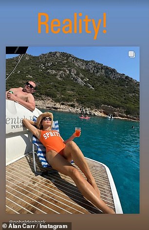 She held a glass of Aperol spritz as a nod to her bathing suit and she relaxed beneath black sunglasses as she rested an arm behind her head