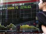 A person walks in front of an electronic stock board showing Japan's Nikkei 225 index Friday, Aug. 2, 2024, in Tokyo. Shares in Europe and Asia tumbled Friday, with Japan's Nikkei 225 index slumping 5.8% as investors panicked over signs of weakness in the U.S. economy. (Kyodo News via AP)