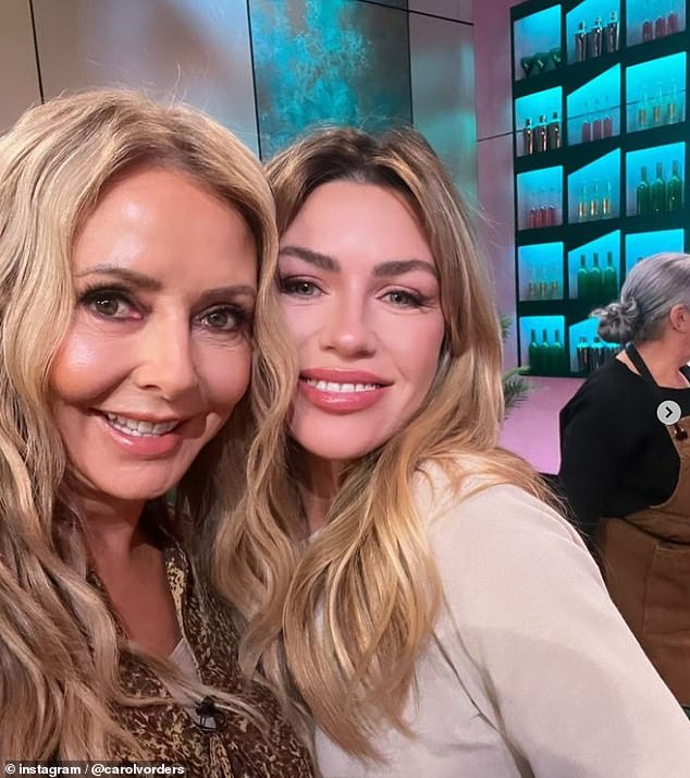 The TV star posing with model Abbey Clancy on the set of the ITV's cooking show which sees celebrities paired with professionals to inspire them in the kitchen (pictured July 31)