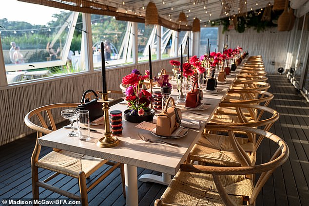 The white table was decorated with red and purple flower bouquets, and accented by tall candles.