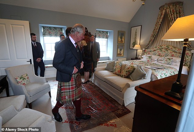 King Charles viewing a bedroom in  the luxury new lodge when it opened in 2019