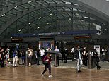 London's Canary Wharf tube station is evacuated after 'man falls from height' with police yelling 'get out as quickly as you can' - as panicked people are seen sprinting away