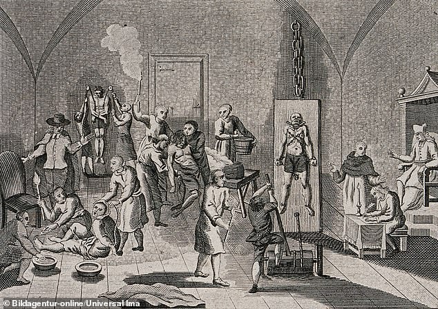 The interior of a prison of the Spanish Inquisition with a priest overseeing his scribe while men and women are hung from pulleys, tortured on the rack or burned with torches, The Spanish Inquisition was a council to combat heresy, authorised by a papal bull in 1478 and established by King Ferdinand II and Queen Isabella of the Crown, in 1480