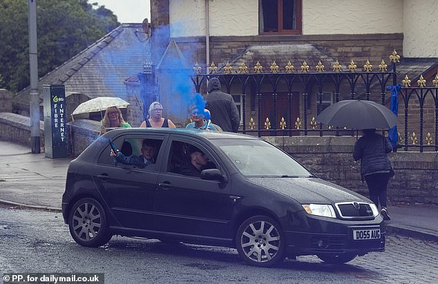 One car set off a blue flare as they approached the church