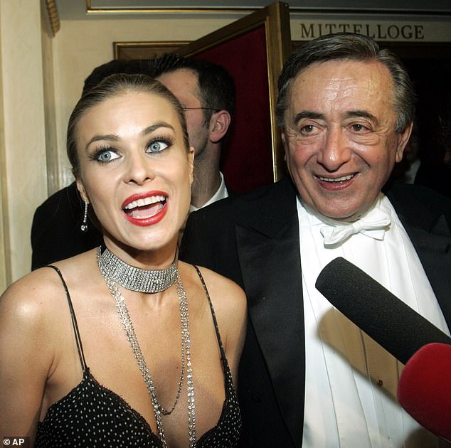 U.S. actress Carmen Electra talks to reporters as her host Austrian businessman Richard Lugner listens during the traditional Opera Ball, on Thursday, February 23, 2006