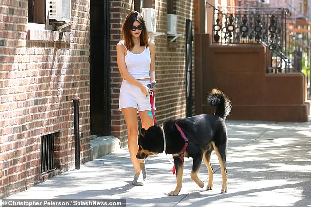 She guided her dog on a bright red leash