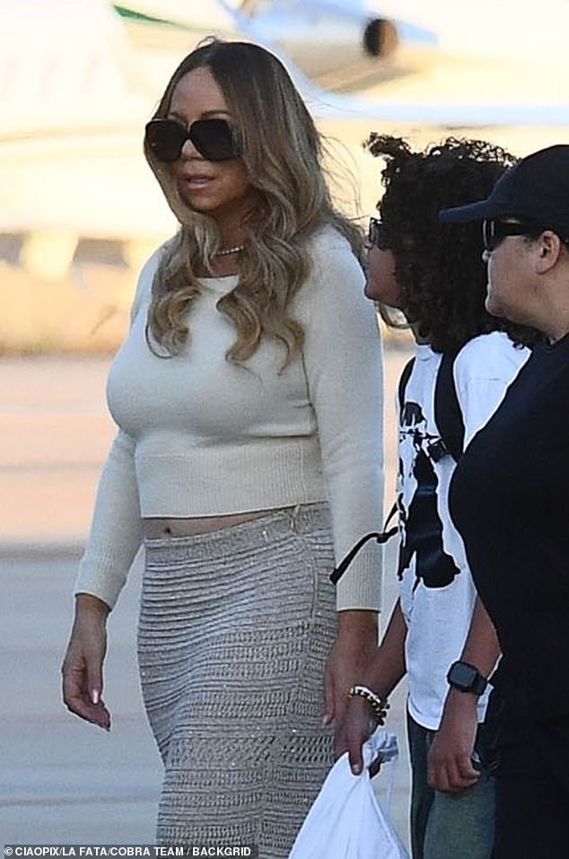 The 55-year-old singer showed a sliver of her tummy in a snug-fitting beige top and textured maxi skirt