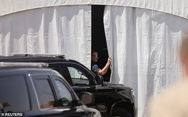 A U.S. Secret Service agent opens the blind that houses the presidential limousine the Beast in Las Vegas