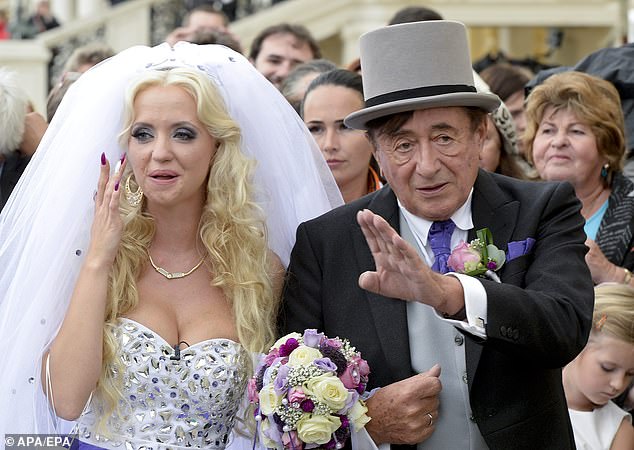 Richard Lugner (R) waves next to Cathy Schmitz (L) after their wedding ceremony at the Schloss Schoennbrunn in Vienna, 2014