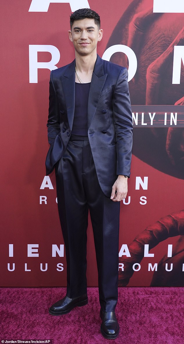 Archie looked dapper for the premiere as he wore a trendy navy satin suit, complete with high-waisted pants and a casual vest