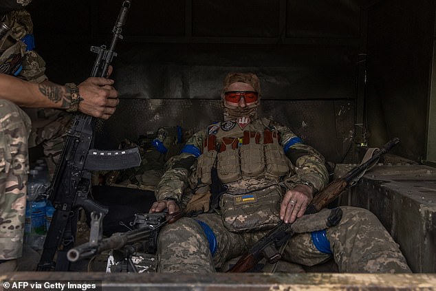 Ukrainian servicemen wait in a military vehicle to head for a combat mission, in the Sumy region, near the border with Russia, on August 13, 2024