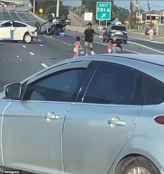 As the two kids were left stranded in the middle of the 14-lane highway, two men can be seen running towards them and catching ahold of them while asking for help