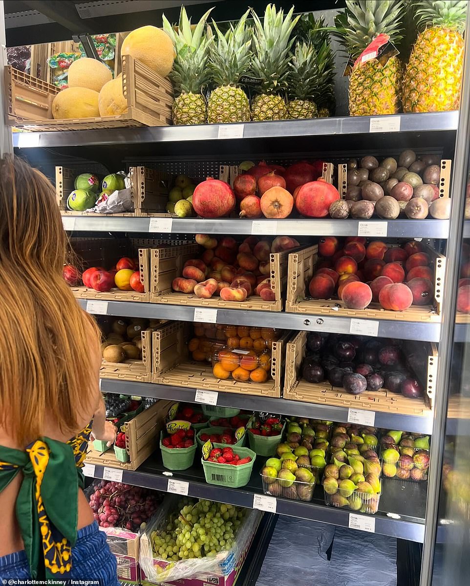 The model also shared a photo of the fruit section of a market as she wore a scarf top and denim skirt