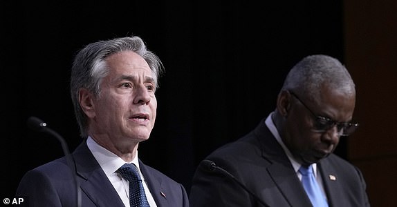 Secretary of State Antony Blinken, left, standing with Defense Secretary Lloyd Austin, right, speaks during a news conference at the United States Naval Academy in Annapolis, Md., Tuesday, Aug. 6, 2024. (AP Photo/Susan Walsh)