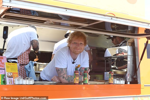 He looked effortlessly cool as ever in a white T-shirt as he served up the tasty treats for punters