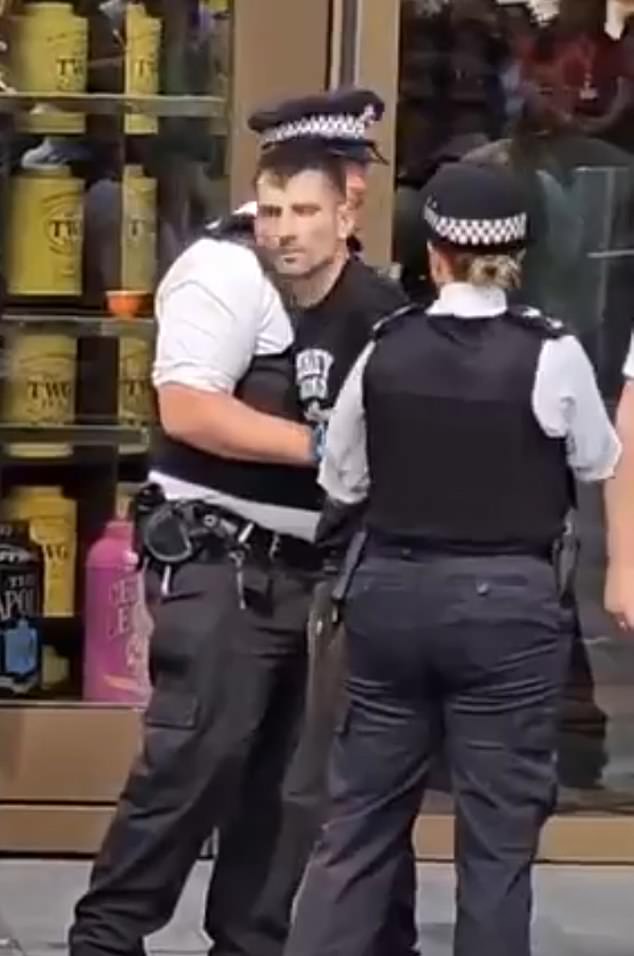 Police were seen detaining a man in Leicester Square after an 11-year-old girl was stabbed on Monday