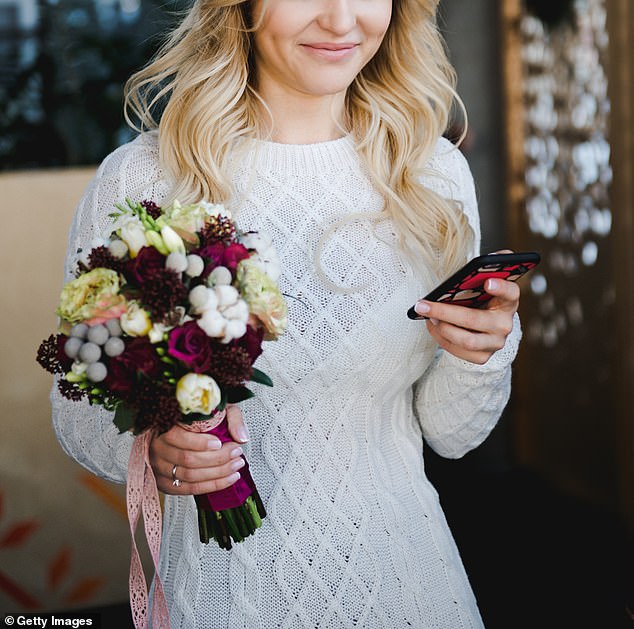 The bride randomly checked her phone on her wedding day - only to learn she no longer had a job (stock image)