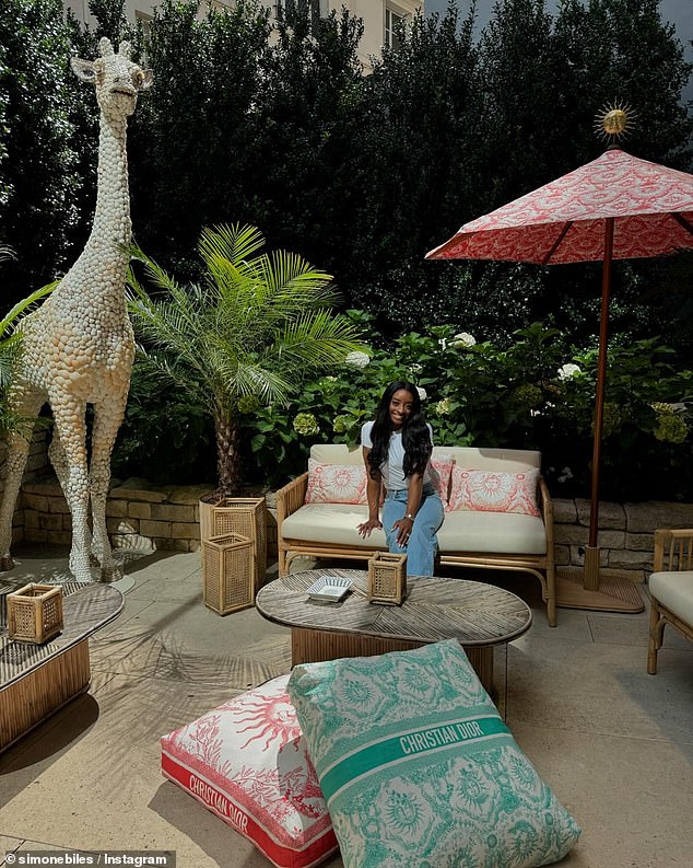 The Team USA superstar posed at the Dior Café, adorned with monogrammed cushions