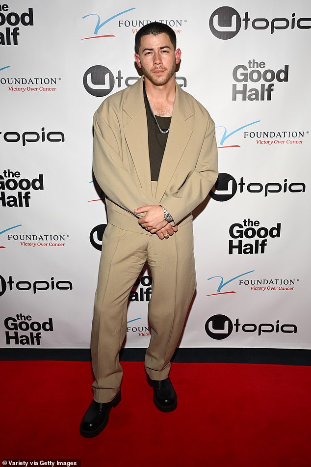 Jonas modeled an oversized beige blazer with matching high-waisted slacks