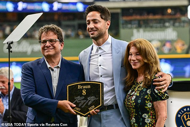 Attanasio, pictured with the Brewers' Ryan Braun and wife Debbie, bought his baseball team in 2004 and seized control of England¿s Norwich City soccer club on Monday