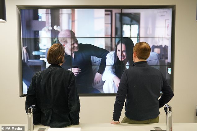 Office workers in London, watching the Duke and Duchess of Sussex´s Netflix documentary (Jonathan Brady/PA)