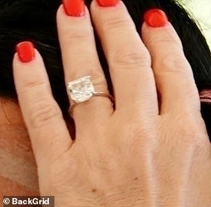 The television personality flashed a huge diamond ring which was set on a gold band