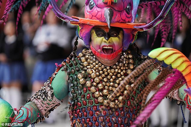 A person takes part in a Colombian folkloric performance as Harry and Meghan visit the country