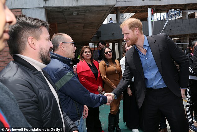 The Duke of Sussex meets people at the Colegio Cultura Popular school in Bogota yesterday