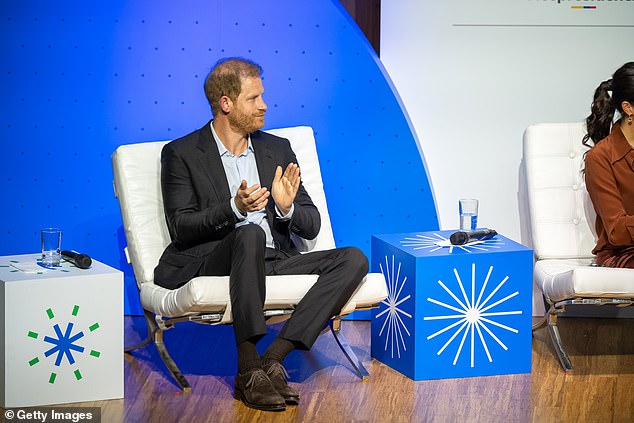 Prince Harry applauds during the Responsible Digital Future forum in Bogota yesterday