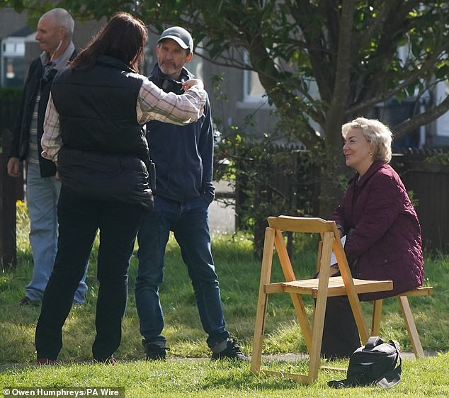 She then sat happily as her co-stars spoke amongst themselves