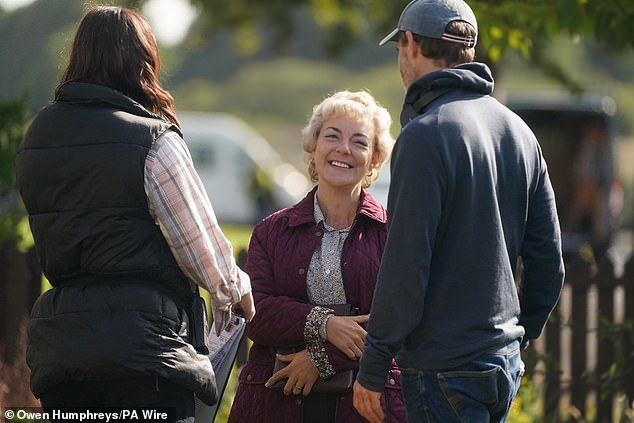 Sheridan sported a dark mauve padded jacket and a patterned black and white shirt for filming in Shiremoor