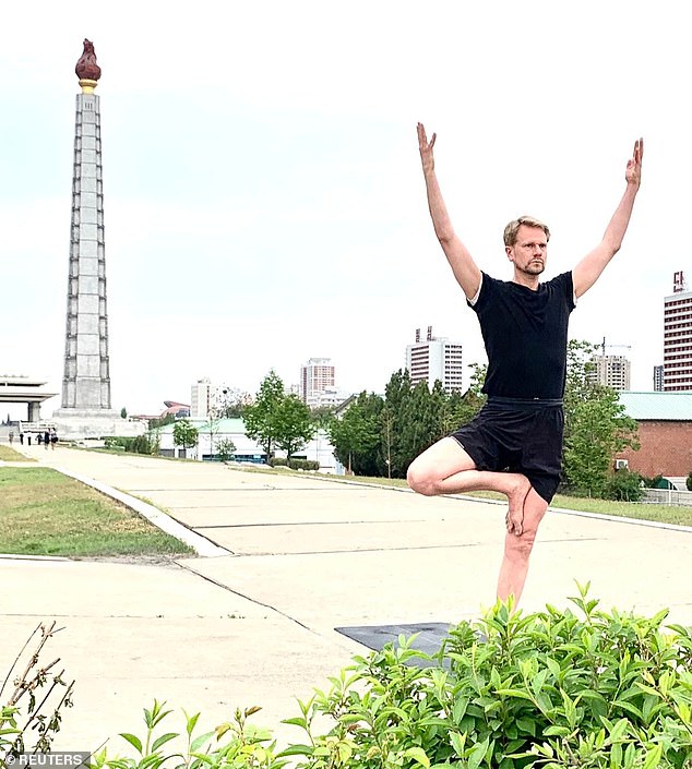 Swedish Ambassador Joachim Bergstrom practices yoga near the Juche Tower in Pyongyang, North Korea, June 21, 2020