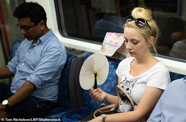 How dangerous a trip on the tube could be depends on both temperature and humidity. Pictured, a woman cools down on the London Underground, July 2018