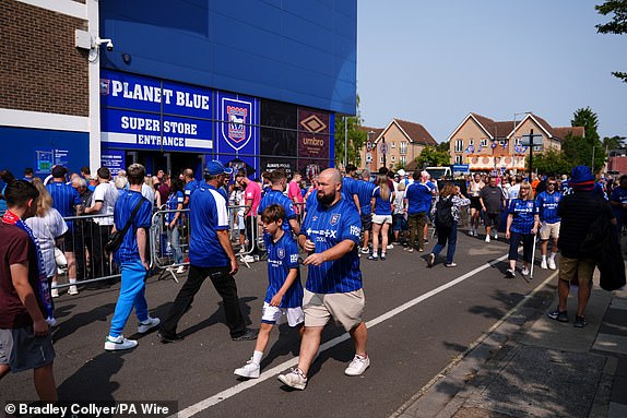 Ipswich Town fans outside the ground ahead of the Premier League match at Portman Road, Ipswich. Picture date: Saturday August 17, 2024. PA Photo. See PA story SOCCER Ipswich. Photo credit should read: Bradley Collyer/PA Wire.RESTRICTIONS: EDITORIAL USE ONLY No use with unauthorised audio, video, data, fixture lists, club/league logos or "live" services. Online in-match use limited to 120 images, no video emulation. No use in betting, games or single club/league/player publications.