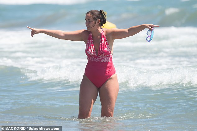 The TV star put on a jovial display while having fun on the shore