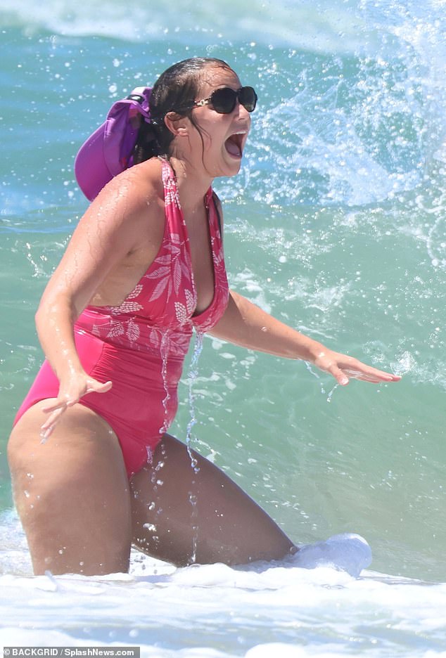 However, the mother-of-two pulled a shocked expression as one point as she was splashed by the presumably cool water