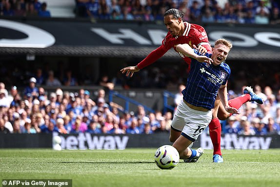 Liverpool's Dutch defender #04 Virgil van Dijk (rear) fights for the ball with Ipswich Town's English midfielder #19 Liam Delap during the English Premier League football match between Ipswich Town and Liverpool at Portman Road in Ipswich, eastern England on August 17, 2024. (Photo by HENRY NICHOLLS / AFP) / RESTRICTED TO EDITORIAL USE. No use with unauthorized audio, video, data, fixture lists, club/league logos or 'live' services. Online in-match use limited to 120 images. An additional 40 images may be used in extra time. No video emulation. Social media in-match use limited to 120 images. An additional 40 images may be used in extra time. No use in betting publications, games or single club/league/player publications. /  (Photo by HENRY NICHOLLS/AFP via Getty Images)