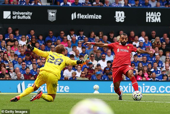 IPSWICH, ENGLAND - AUGUST 17: Mohamed Salah of Liverpool scores his team's second goal past Christian Walton of Ipswich Town during the Premier League match between Ipswich Town FC and Liverpool FC at Portman Road on August 17, 2024 in Ipswich, England. (Photo by Marc Atkins/Getty Images)