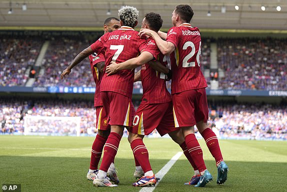 Liverpool's Diogo Jota, second right, celebrates after he scores his side's first goal during the English Premier League soccer match between Ipswich Town and Liverpool at Portman Road stadium in Ipswich, England, Saturday, Aug. 17, 2024. (AP Photo/Alastair Grant)