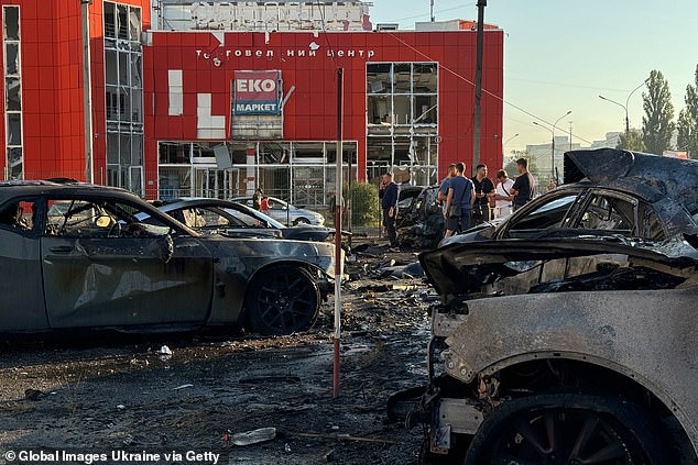 Russian attacks in Ukraine have continued regardless of the border conflicts (pictured: residents of Sumy surveying the damage of a Putin missile strike)