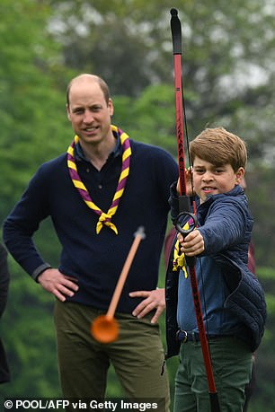 Prince George tries his hand at archery while taking part in the Big Help Out, during a visit to the 3rd Upton Scouts Hut in Slough, west of London on May 8, 2023