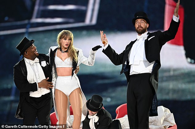 Looking ahead they concluded Monday's show, which had a top hat symbol, would see Taylor's boyfriend Travis Kelcee (R)  return to the Wembley  (pictured on stage in June)