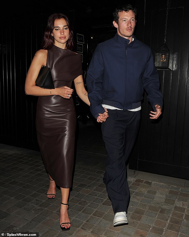 Meanwhile, Callum cut a laidback figure for their date night wearing a navy bomber jacket with a high collar